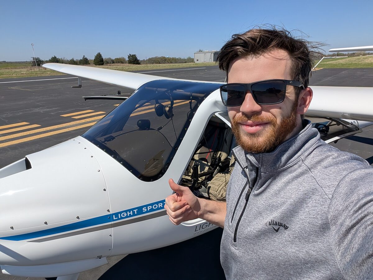 Zach next to a Pipistrel light sport aircraft at the airfield